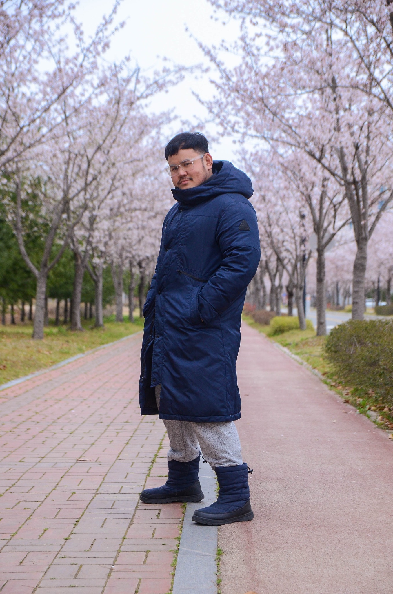 Pinoy scientist Joseph Bandoy posing in front of cherry blossoms