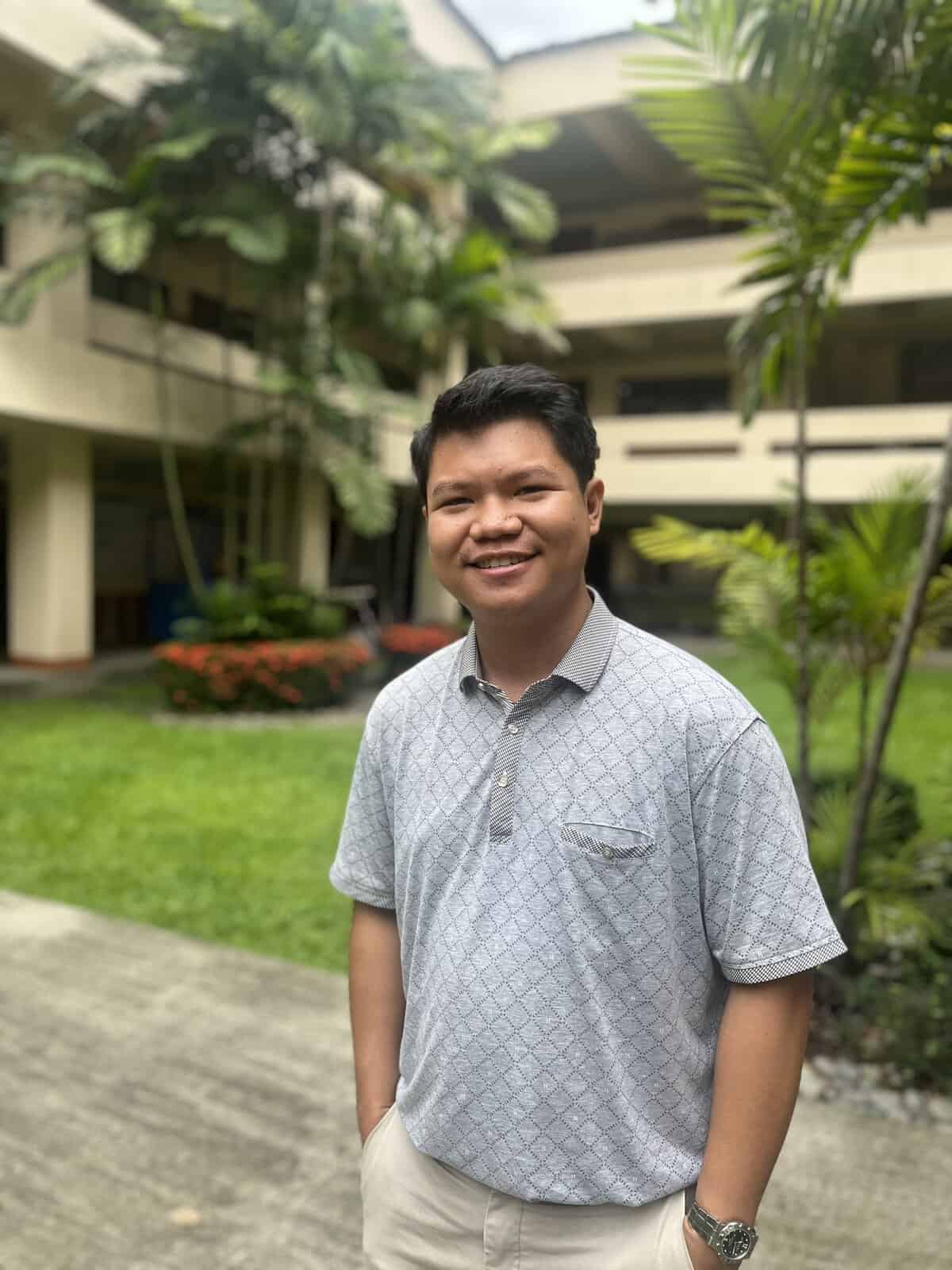 Pinoy Scientist Keith Nealson Penado is wearing a light grey polo shirt, smiling at the camera. He has short black hair and a relaxed demeanor.