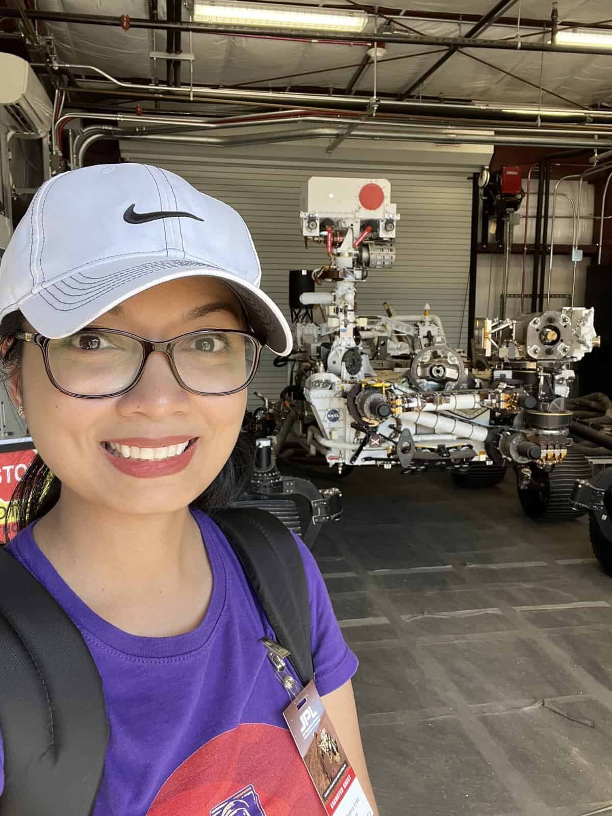 Pinoy scientist Ericka Rivera smiles for a selfie in front of a robotic Mars rover
