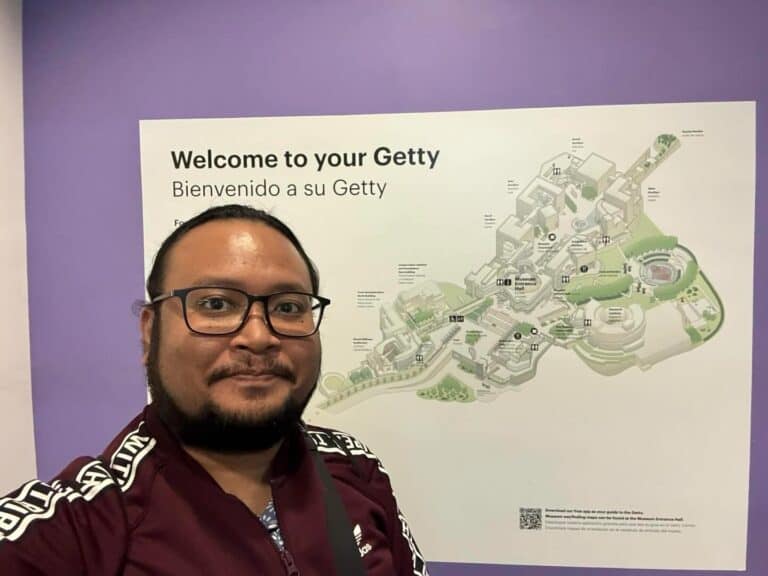 Pinoy scientist Julius Lustro has glasses, a short beard, and wearing a maroon jacket.