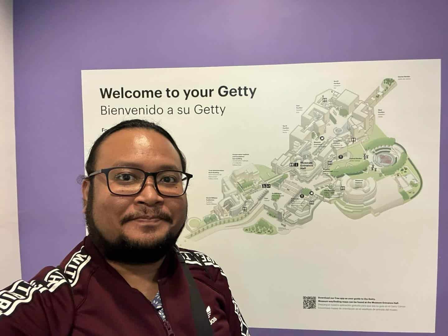 Pinoy scientist Julius Lustro has glasses, a short beard, and wearing a maroon jacket.