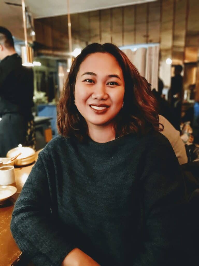 Pinoy scientist Reneepearl Kim Sales smiling at a restaurant table.