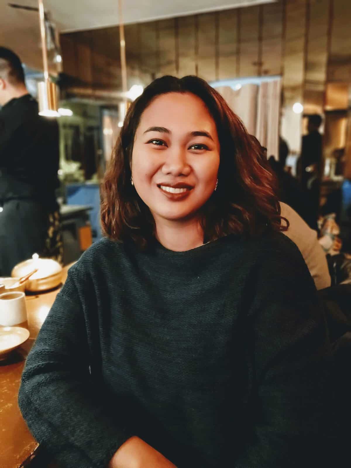 Pinoy scientist Reneepearl Kim Sales smiling at a restaurant table.